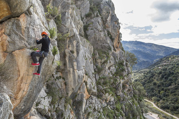 Woman climbing a via ferrata