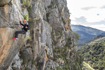 woman climbing a via ferrata