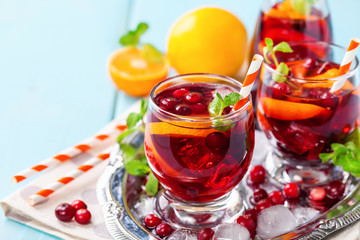 Summer drink Sangria with orange and cranberry. Selective focus. Copy space