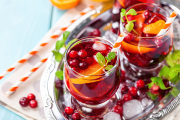 Summer drink Sangria with orange and cranberry. Selective focus. Copy space