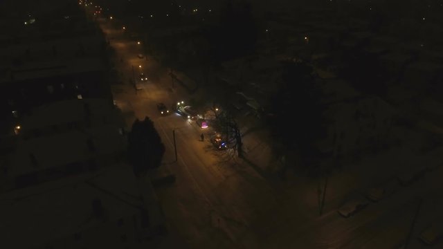 Cops help tow truck taking car off snow road