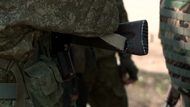 Close-up military ak-47 weapon on camouflage background