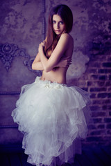 Beautiful female brunette model in white skirt