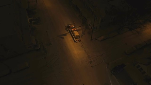 Tow truck taking car off snow road for cops