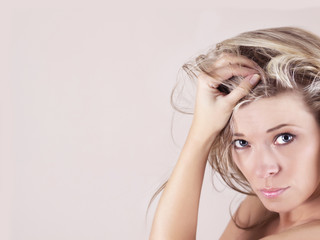 Obraz premium Portrait of sexy young woman with hand in hair