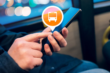 Woman using mobile phone app to purchase bus electronic ticket
