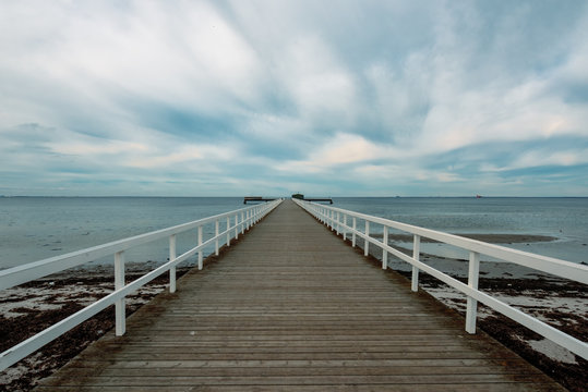 Empty wooden pier walkway on sea shore © Bits and Splits