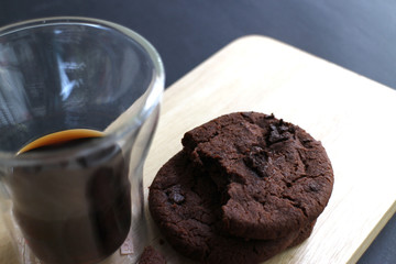 Black coffee in a double wall glass and Chocolate chips cookies