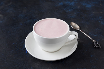 Cappuccino with berries in a porcelain cup