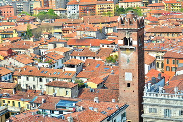 Fototapeta na wymiar The great medieval tower with the oldest mechanical clock in Verona, Italy; panoramic photo.