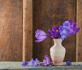 spring flowers in vase on wooden background