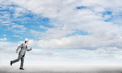 King businessman in elegant suit running and blue sky at background