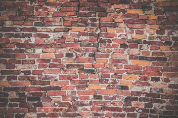 Old, worn, red bricks wall with gap. Background. Vintage style.