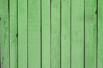 green old wooden fence. wood palisade background. planks texture