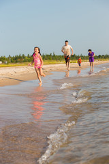Obraz premium Mixed Race family at the beach