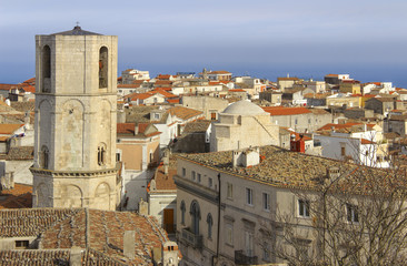Obraz premium Panorama of Monte Sant'Angelo: it is a town on the slopes of Gargano.View of octagonal bell tower of Saint Michael Archangel Sanctuary at Monte Sant'Angelo on Italy (Apulia). 