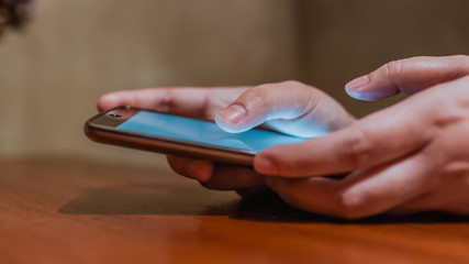 A woman's hand is playing a smartphone.