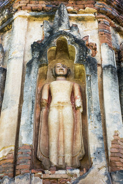 Ruin standing Buddha image statue on the old pagoda