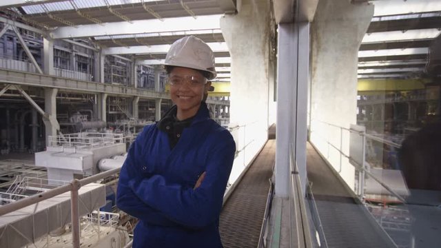  Interior view of huge industrial power plant & smiling female engineer