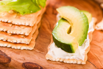 Crackers with ham and avocado. 