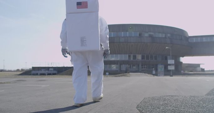  Astronaut looking for signs of life outside abandoned power station