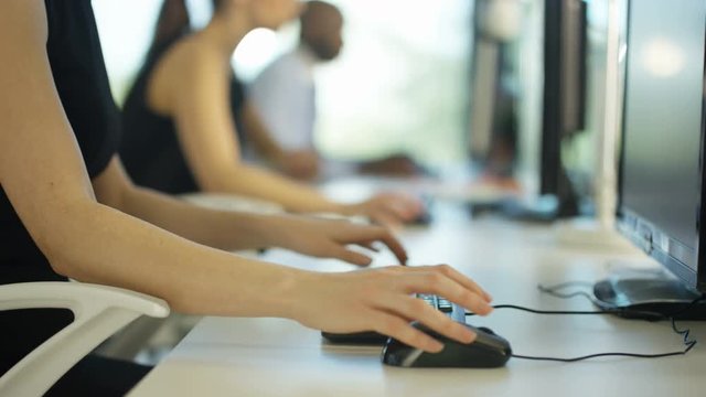  Close up on hands of unrecognizable worker working on computer in city office