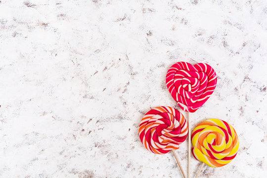 Colorful lollipops on white background. Top view