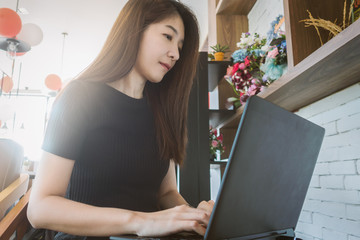 business woman working on laptop and looking at screen in home office as agile technology concept.