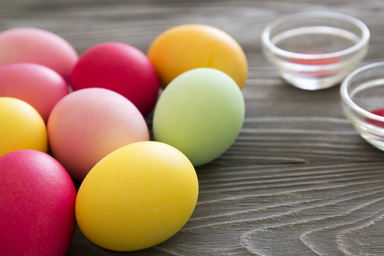 Colored painted eggs and color pigments. Celebrating Easter