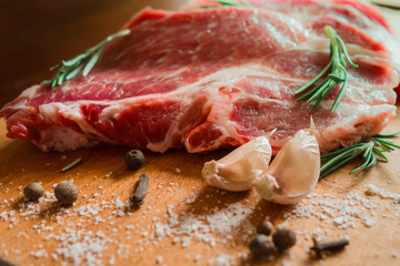 Raw fresh meat on Board with condiments. Beautiful meat on the Board. Conceptual photos.