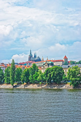 Fototapeta na wymiar Vltava River embankment and Prague Old Town with Strakova Academy