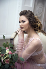 bride's morning. Young girl posing in pink sheer nightie