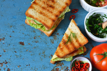 Toasts with chicken and vegetables on a blue, old background