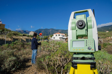 Modern surveyor equipment, theodolite or tacheometer  used in surveying and building construction for precise measurement. Total station outdoor at construction site.