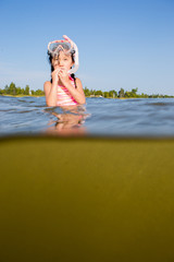 Girl playing at the beach with snorkel