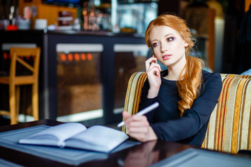 Business woman leading business conversation on the phone in restaurant