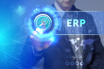 Business, Technology, Internet and network concept. Business man working on the tablet of the future, select on the virtual display: ERP