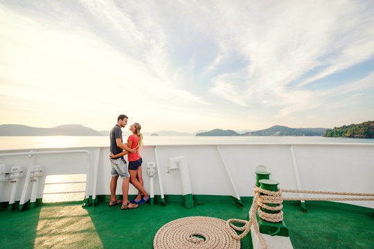 Romantic vacation. Young loving couple enjoying sunset on cruise ship deck. Sailing the sea.