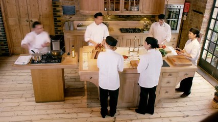  Time lapse of professional chef teaching young trainees in cookery school