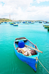 Luzzu colorful boat at Marsaxlokk Harbor in Malta