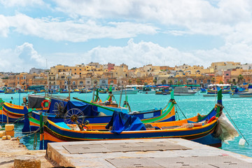 Fototapeta na wymiar Luzzu colorful boats at Marsaxlokk Bay on Malta