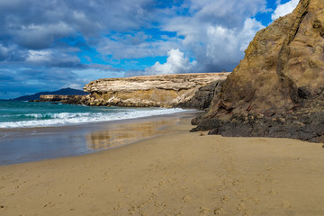 Spain, Canary Islands, Fuerteventura, La Pared. Beach with volcanic clifs