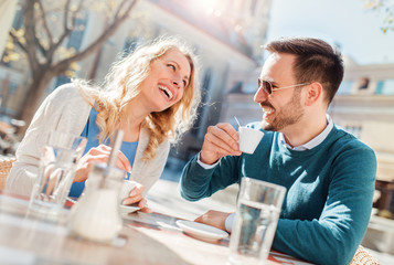 Romantic loving couple drinking coffee, having a date in the cafe. Dating, love, relationships