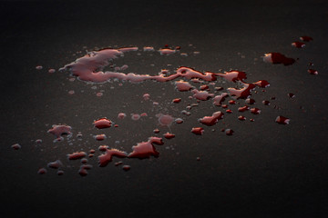 Spilled blood on black surface