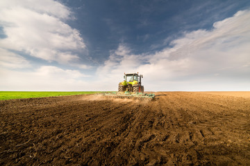 Fototapeta premium Tractor preparing land