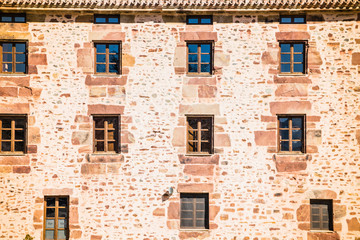 Fototapeta na wymiar The windows of the stone-made house