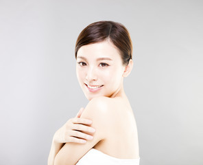 young smiling woman face with gray background