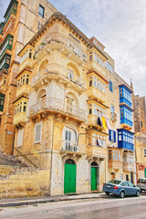Old street with traditional houses in city center in Valletta
