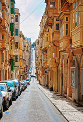 Naklejka na ściany i meble Old street with traditional houses in city center of Valletta