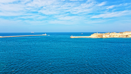 Fototapeta na wymiar Ship at Breakwaters of Fort Ricasoli Kalkara St Elmo Valleta